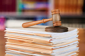 stake of files with a gavel on top