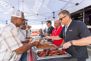 Oil & Natural Gas BBQ Competition, showcasing some of the best oilfield cookers. people in line getting BBQ