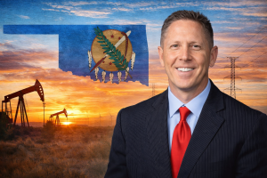 Congressman Josh Brecheen in front of the Oklahoma state and oil derricks and power lines