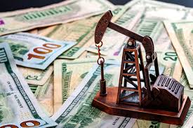 oil derrick on top of money