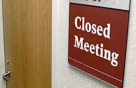door with closed meeting sign